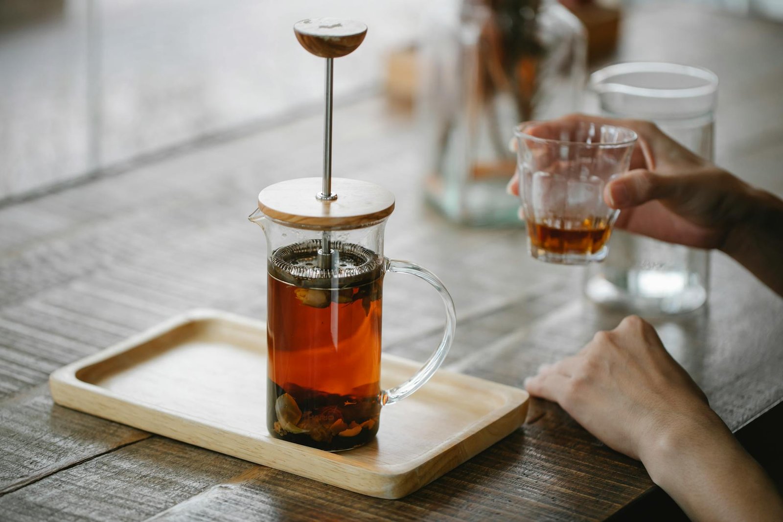 crop unrecognizable woman drinking fresh black tea